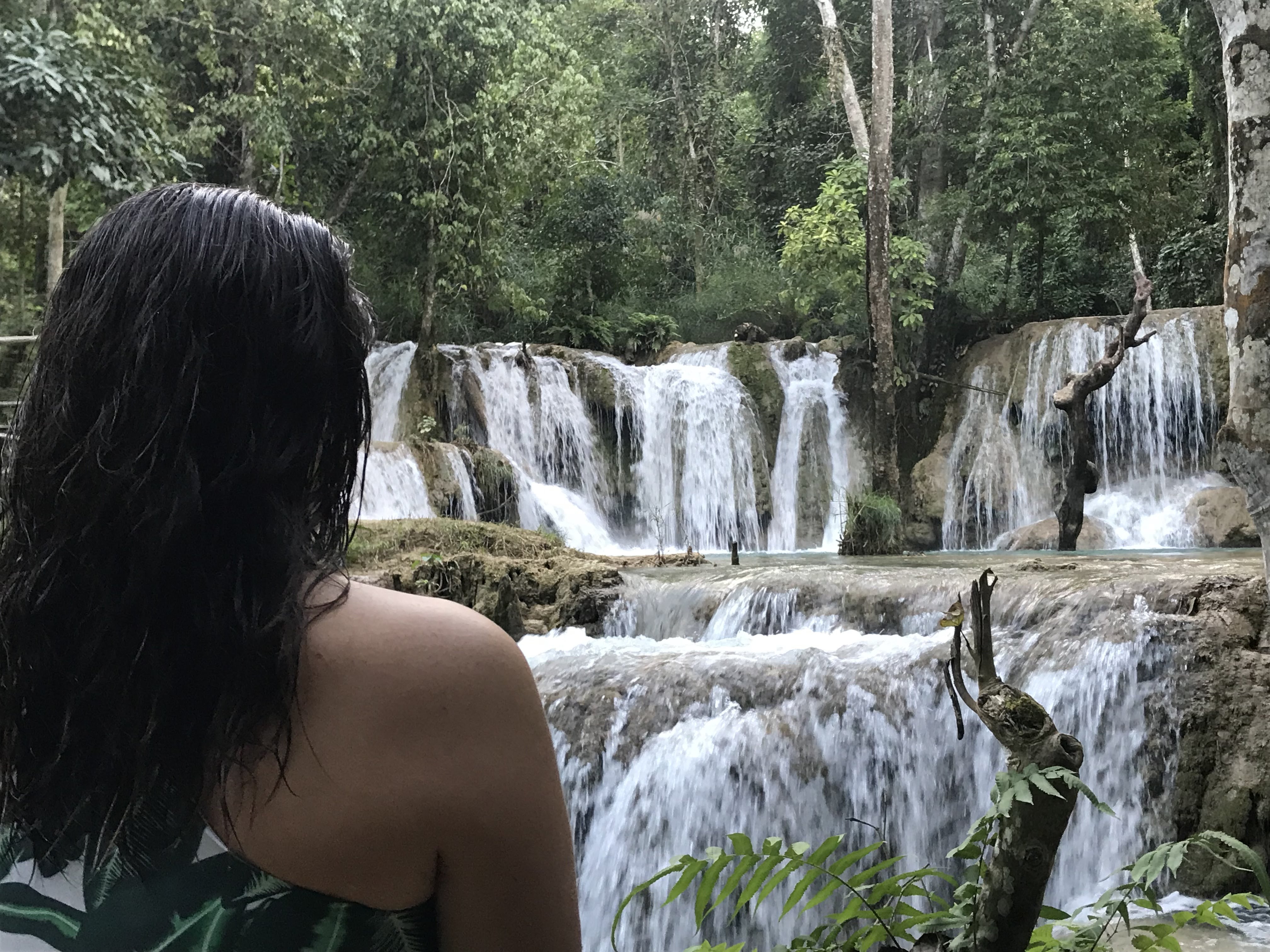Girl looking towards Tad Sae Waterfalls in Luang Prabang, Laos